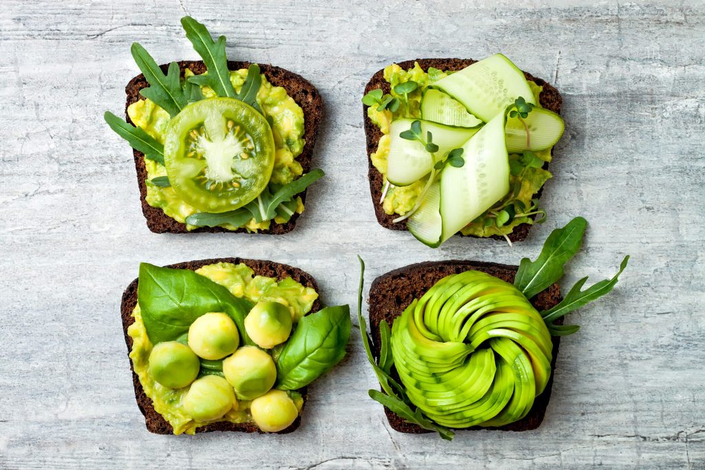 Avocado toast top-down view with various green toppings